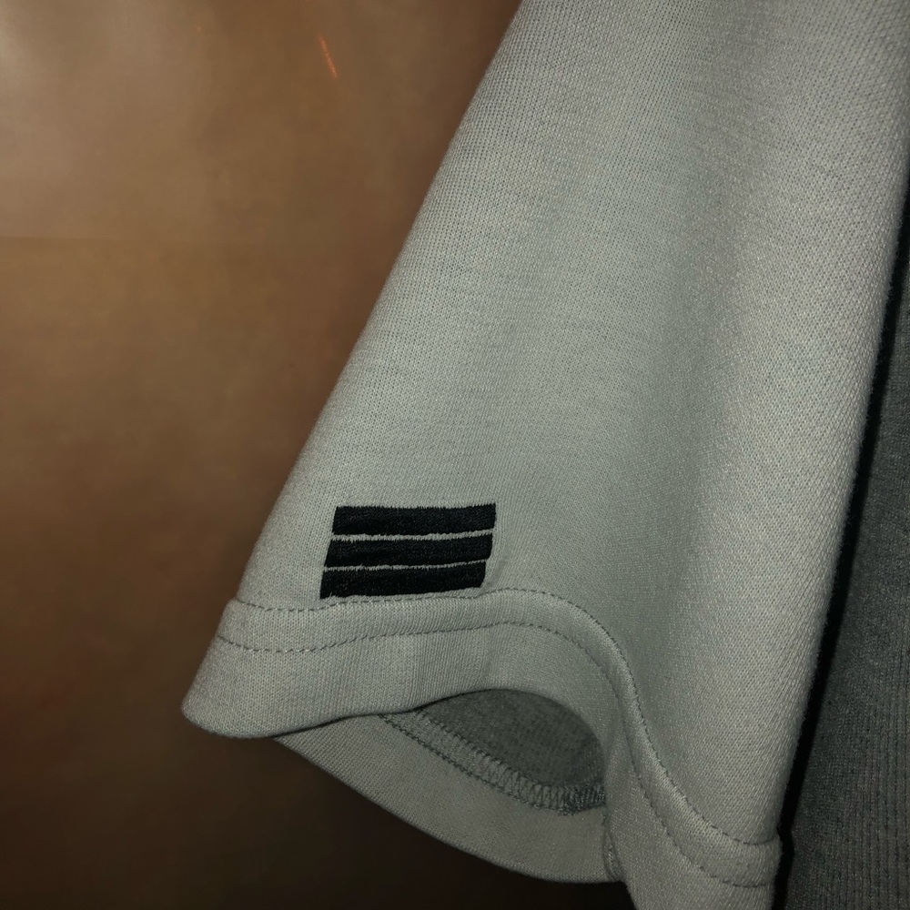 I’m selling a large size Adidas shirt, vintage in good condition.